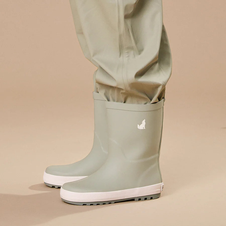 Crywolf Rain Boots Moss with sage green rain pants on a beige background.