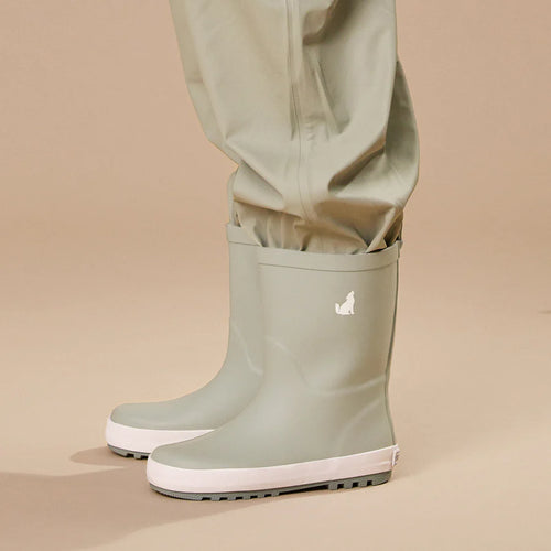 Crywolf Rain Boots Moss with sage green rain pants on a beige background.