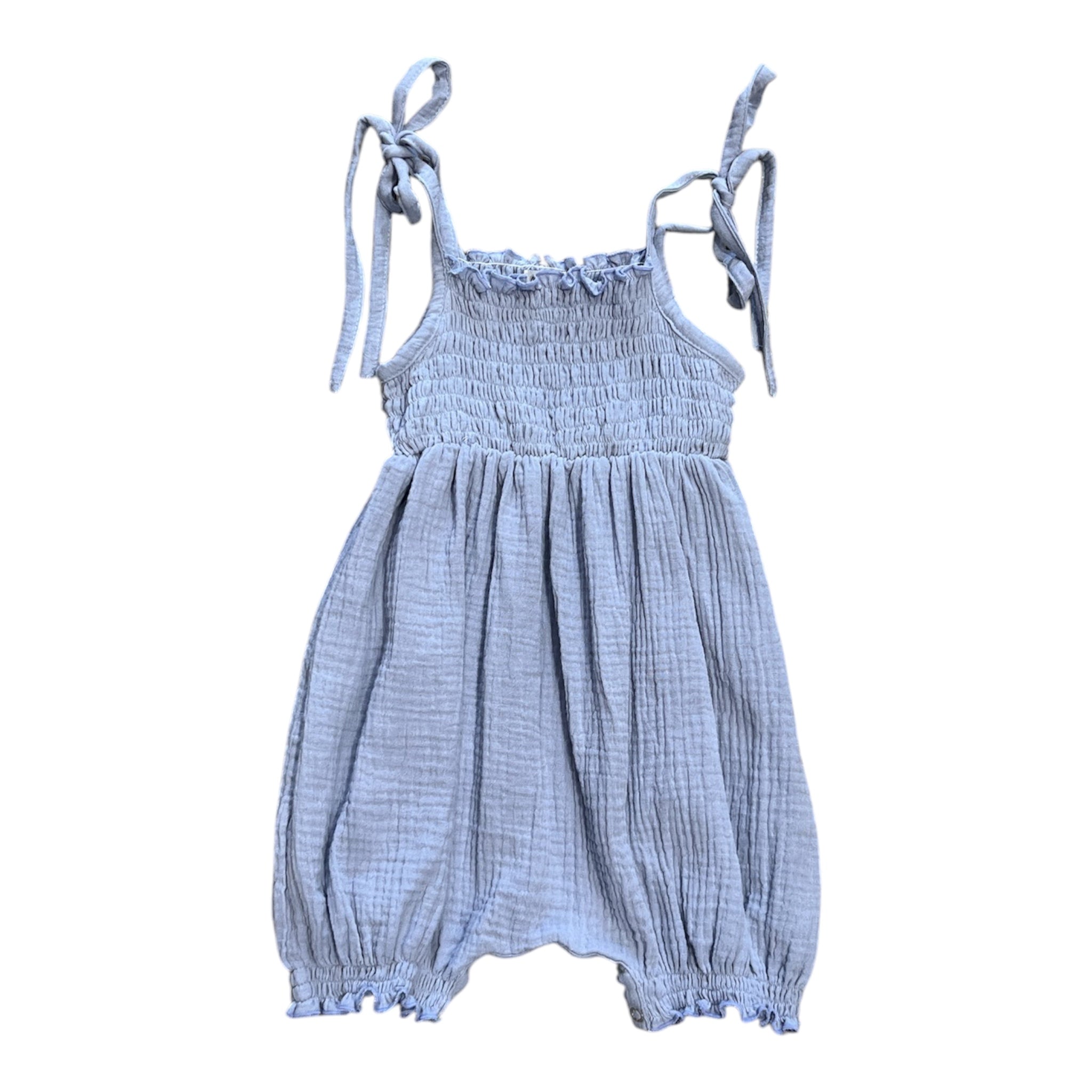 A light blue crinkle gauze baby romper with a smocked bodice, tie shoulder straps, and a ruffled neckline, shown against a plain white background.