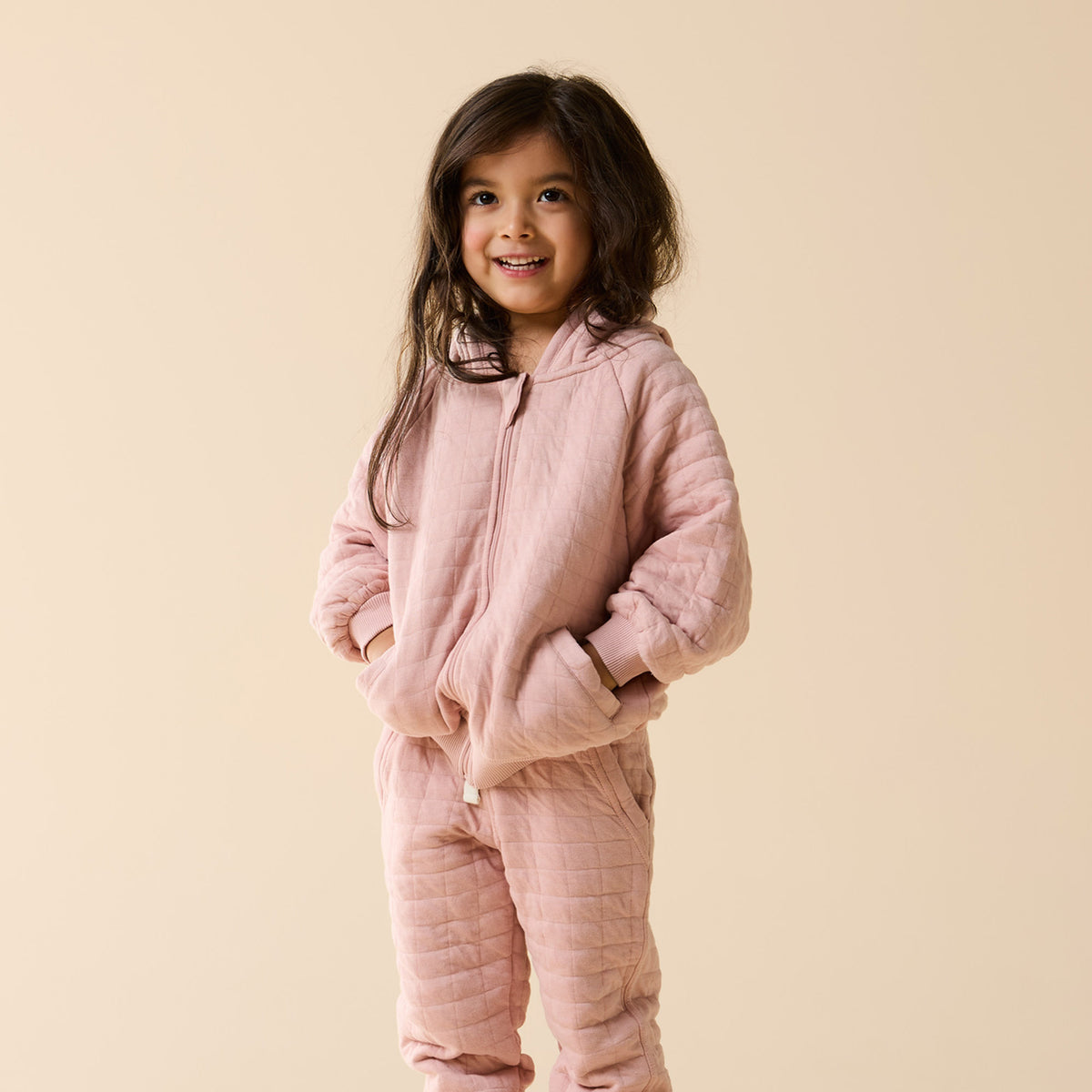 Child wearing a Wilson & Frenchy Rose Organic Quilted Jacket.